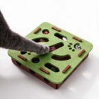 Cat paw reaching through an opening in the felt puzzle toy
